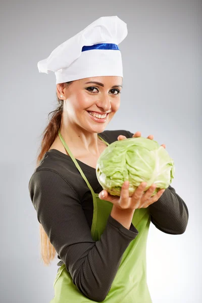 Female cook holding a white cabbage — Stock Photo, Image