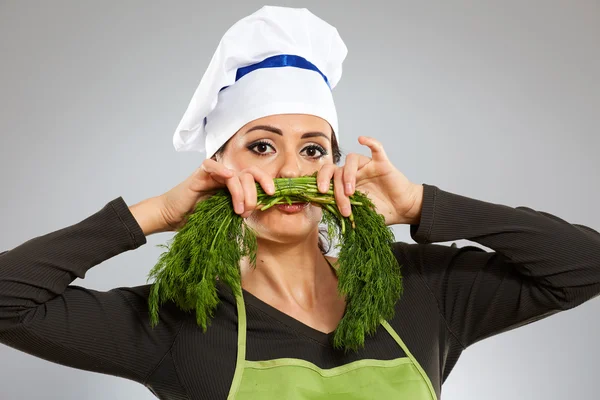 Cook making a moustache out of dill — Stock Photo, Image