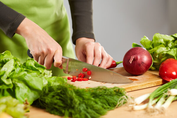  hands chopping vegetables