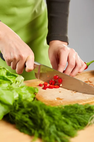 Mãos cortando legumes — Fotografia de Stock