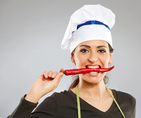 Woman biting hot chili pepper Royalty Free Stock Images