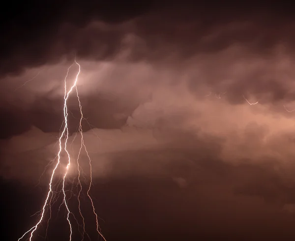Lightning bolt hitting among the clouds — Stock Photo, Image