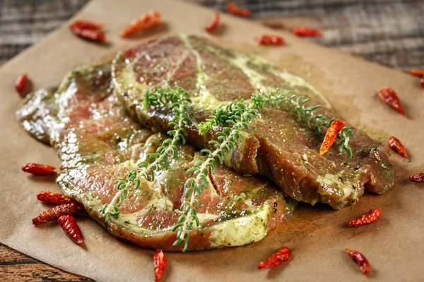 Gewürztes Schweinefleisch auf einem Holzbrett — Stockfoto