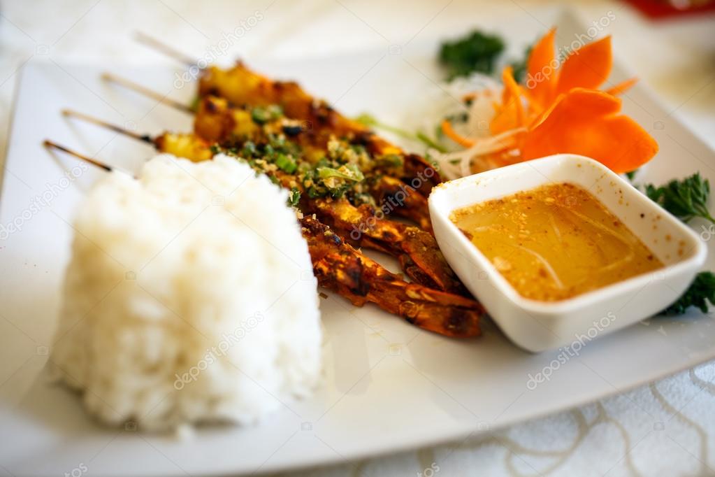 Shrimp skewers with rice and sauce Stock Photo by ©Xalanx 123640796
