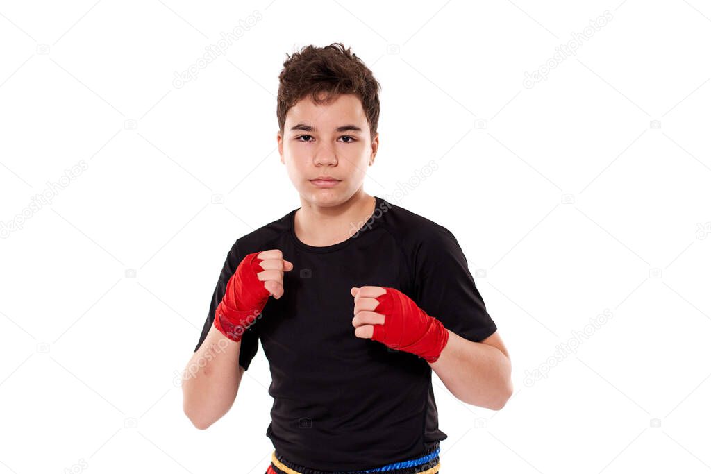 Young kickboxer training shadow boxing, isolated on white background