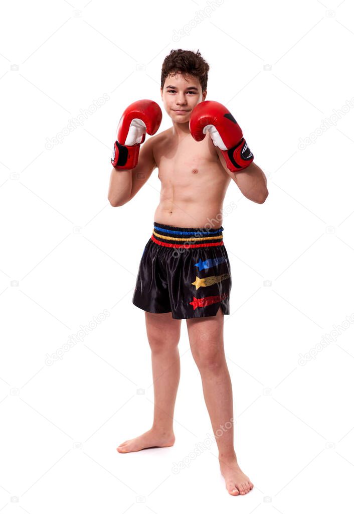 Young kickboxing fighter in red gloves with various strikes posing on white background