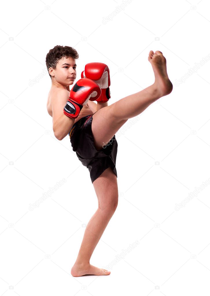 Young kickboxing fighter in red gloves with various strikes posing on white background