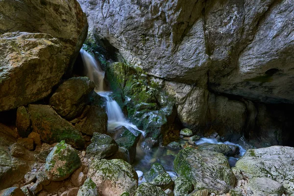 Unterirdischer Fluss Und Wasserfall Auf Bemoosten Felsbrocken Einer Höhle — Stockfoto