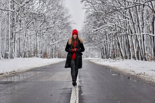 一个美丽的高加索女人在穿越雪地森林的路上的画像 — 图库照片