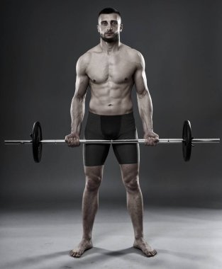 Gri arka planda izole edilmiş halterli genç sporcu eğitimi.