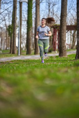 Bahar zamanı parkta koşan kadın boyu.
