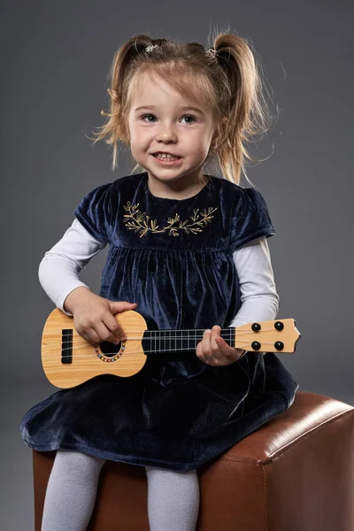 Adorable Little Blond Girl Playing Guitar Studio Shot Gray Background — Stock Photo, Image