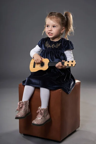 Adorable Little Blond Girl Playing Guitar Studio Shot Gray Background — Stock Photo, Image