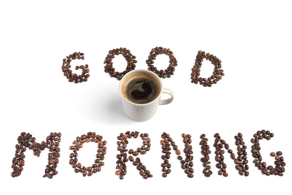 Good morning written with coffee beans around a coffee cup, isolated on white background