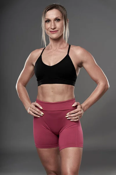 Passform Bodybuilder Kvinna Gör Fitness Övningar Grå Bakgrund Studio Skott — Stockfoto