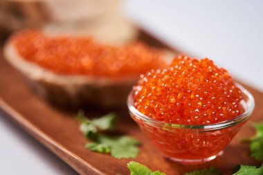 Appetizer with salmon roe on traditional bread clipart