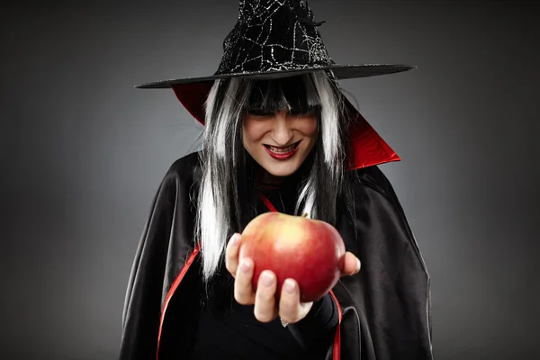 Sorcerer offering a poisoned apple — Stock Photo, Image