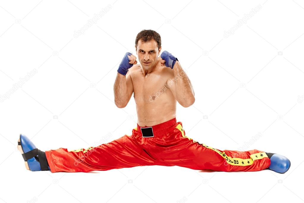 Kickboxer isolated executing a split