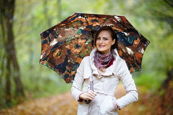 Woman with umbrella in forest — Stock Photo, Image