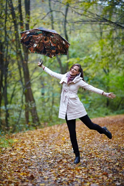 Woman with umbrella in forest — Stock Photo, Image
