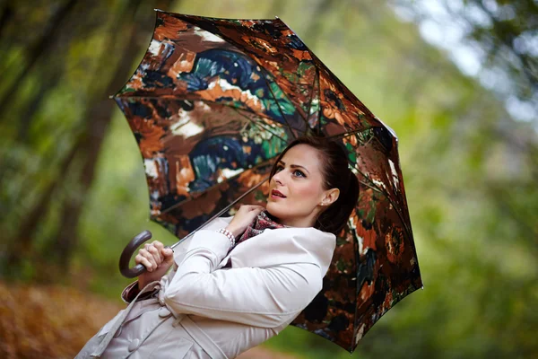 Woman with umbrella in forest — Stock Photo, Image