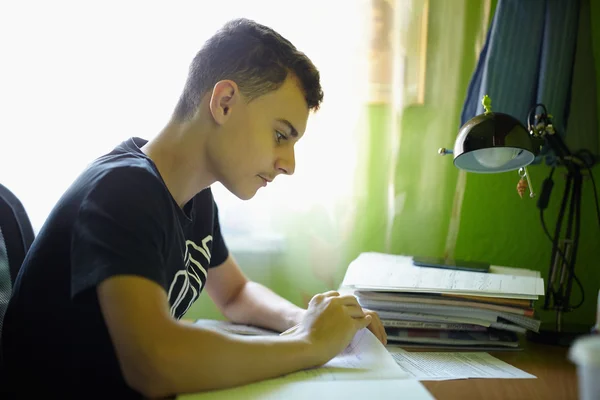 Adolescente menino fazendo lição de casa — Fotografia de Stock