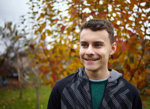 Teenage boy outdoor in an orchard — Stock Photo, Image