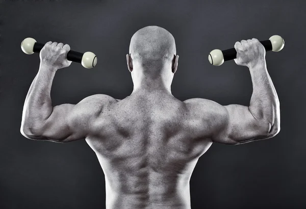 Strong man with dumbbells — Stock Photo, Image