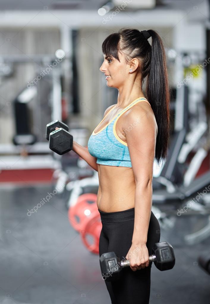Fitness woman biceps workout Stock Photo by ©Xalanx 62844823