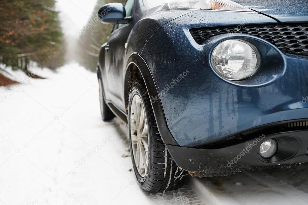 Close up of a cars light on a snowy road