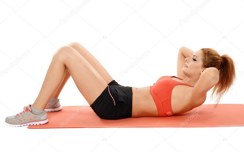 Woman doing abs crunches on a mat