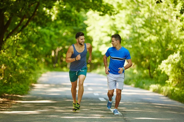 Friends running through forest — Stock Photo, Image