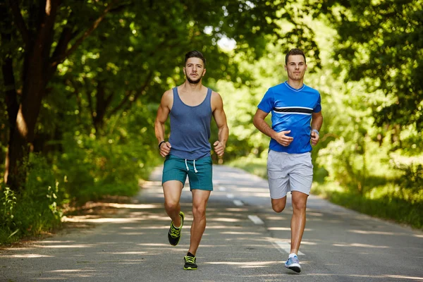 Friends running through forest — Stock Photo, Image