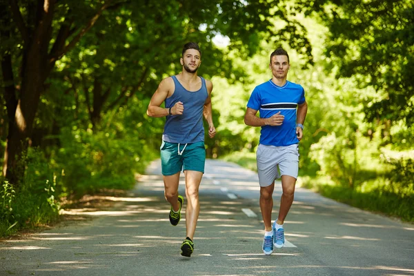 Friends running through forest — Stock Photo, Image