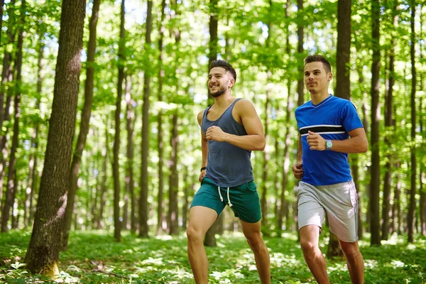 Friends running through forest — Stock Photo, Image