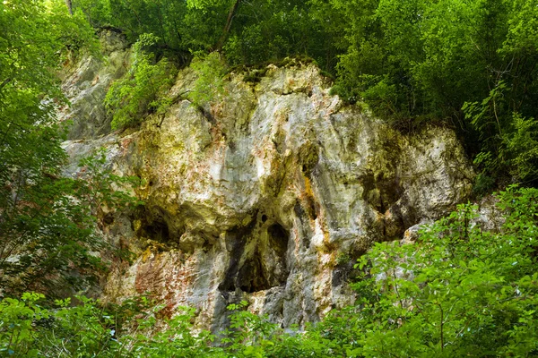 Limestone wall with several holes — Stock Photo, Image