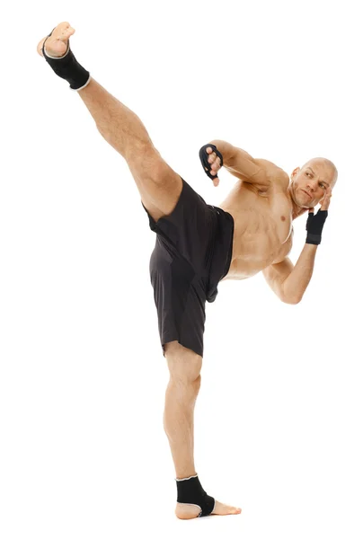 Kickboxer executing a powerful kick — Stock Photo, Image