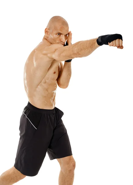 Very fit kickboxer punching — Stock Photo, Image