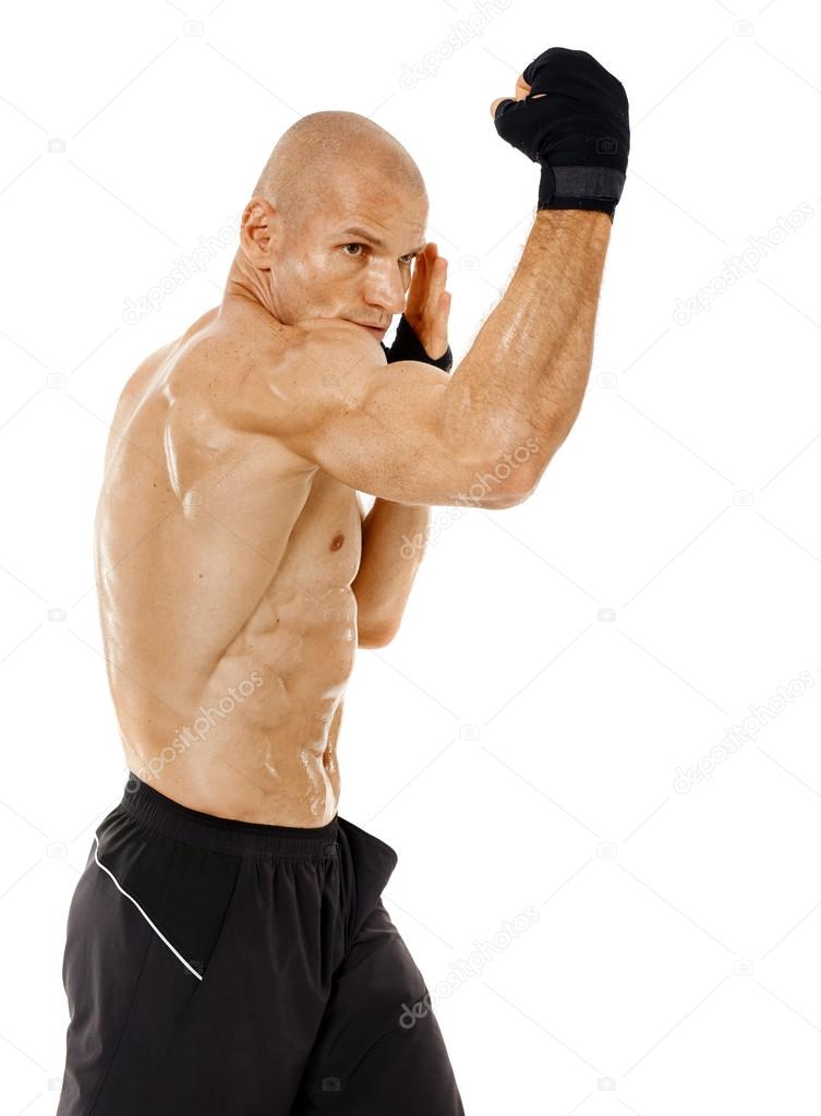 Very fit kickboxer punching