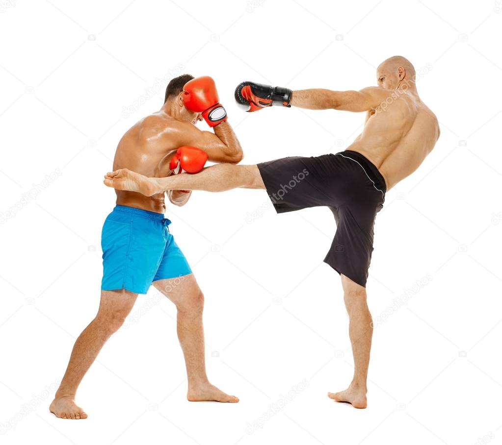 Two kickbox fighters sparring