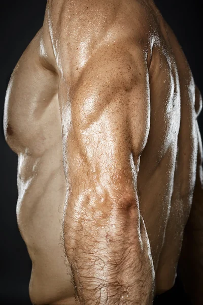 Bodybuilder showing triceps muscle — Stock Photo, Image