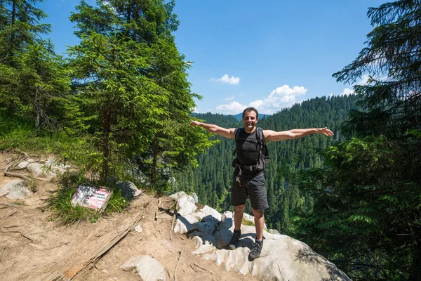 Man with arms raised standing — Stock Photo, Image