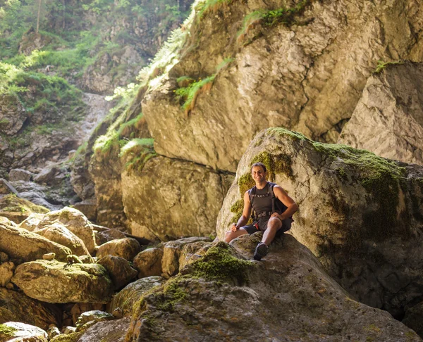 Hiker resting on a large rock Royalty Free Stock Images
