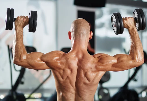 Bodybuilder doing a triceps workout — Stock Photo, Image