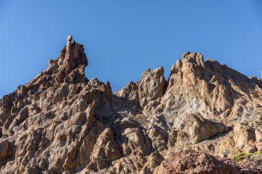 Teide Ulusal Parkı 'ndaki Roques de Garcia' da geniş engebeli kaya oluşumu açık mavi gökyüzünün altında Tenerife 'de popüler bir yürüyüş yolu boyunca fotoğraflandı.