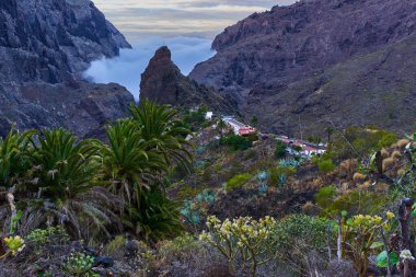 Masca köyü, sabah bulutları ve uçurumlarla çevrili ikonik kaya oluşumuyla dramatik volkanik geçitlerle çevrili.