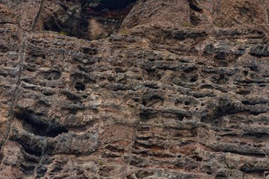 Los Gigantes, Tenerife 'deki canlı turuncu ve kahverengi volkanik katmanlara yakın çekim