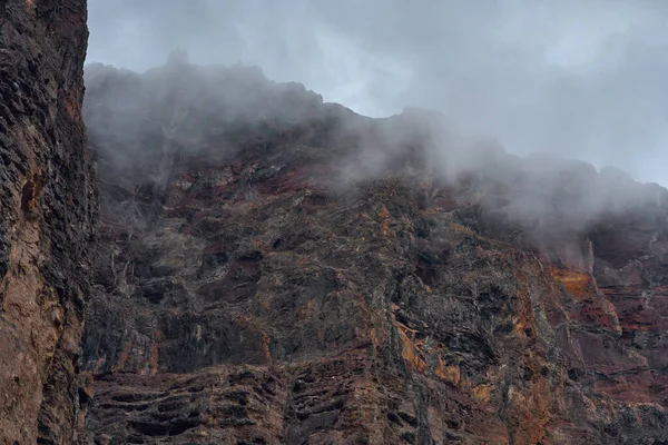 Los Gigantes 'in deniz kayalıklarında farklı mineral bantları gösteren ayrıntılı jeolojik oluşumlar