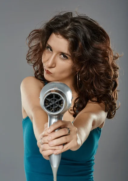 Cheerful woman playing with hairdryer — Stock Photo, Image