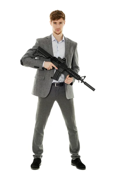 Young man using machine gun — Stock Photo, Image